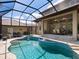 Resort-style pool with a spa and covered patio at 1040 Gulf Winds Way, Nokomis, FL 34275
