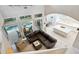 Open living room with high ceilings, overlooking pool and kitchen at 1040 Gulf Winds Way, Nokomis, FL 34275