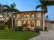 Two-story house with stucco exterior and palm trees at 1040 Gulf Winds Way, Nokomis, FL 34275