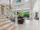 Spacious living room with high ceilings and a view to the pool at 1040 Gulf Winds Way, Nokomis, FL 34275
