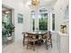 Bright breakfast nook with a round table and chairs, offering a view of the outdoors at 1040 Gulf Winds Way, Nokomis, FL 34275