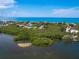 Aerial view of waterfront homes and lush vegetation at 1040 Gulf Winds Way, Nokomis, FL 34275