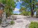 Peaceful courtyard with seating and ocean views at 1040 Gulf Winds Way, Nokomis, FL 34275
