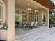 Spacious covered patio with seating area, ceiling fans, and access to the pool at 1040 Gulf Winds Way, Nokomis, FL 34275