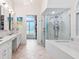 Elegant bathroom with double sinks, large shower, and soaking tub at 1040 Gulf Winds Way, Nokomis, FL 34275