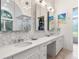Modern bathroom with double vanity and a stylish backsplash at 1040 Gulf Winds Way, Nokomis, FL 34275