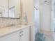 Elegant bathroom with a modern vanity and shower at 1040 Gulf Winds Way, Nokomis, FL 34275