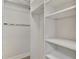 Large walk-in closet with hanging rods and shelving at 137 Bella Vista Ter # 33B, Nokomis, FL 34275