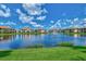 Community lake with fountain and beautiful homes at 137 Bella Vista Ter # 33B, Nokomis, FL 34275