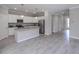 Modern kitchen featuring white cabinets, granite countertops and an island at 10079 Crooked Creek Dr, Venice, FL 34293