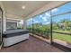 Relax in this screened lanai with a hot tub and view of the lush backyard at 10079 Crooked Creek Dr, Venice, FL 34293