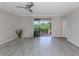 Bright living room with sliding glass doors opening to a backyard at 10079 Crooked Creek Dr, Venice, FL 34293