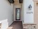 Modern front door with glass panels and brick walkway leading to the entrance at 10079 Crooked Creek Dr, Venice, FL 34293