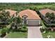 Attractive single-story house with a brick driveway and palm trees at 10079 Crooked Creek Dr, Venice, FL 34293