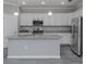 Open concept kitchen with white cabinets, granite countertops, and island at 10079 Crooked Creek Dr, Venice, FL 34293
