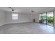 Living room with sliding glass doors leading to a patio and spa at 10079 Crooked Creek Dr, Venice, FL 34293