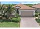 Beautiful one-story home with a two-car garage and lush landscaping at 10079 Crooked Creek Dr, Venice, FL 34293