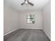 Well-lit bedroom featuring neutral walls and grey carpeting at 10079 Crooked Creek Dr, Venice, FL 34293