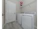 Laundry room with washer, dryer, and overhead shelving at 10079 Crooked Creek Dr, Venice, FL 34293