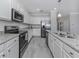 Modern kitchen with stainless steel appliances and granite countertops at 10079 Crooked Creek Dr, Venice, FL 34293