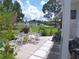 Relaxing patio area with table, chairs, and surrounding greenery at 6810 Alani Ct, North Port, FL 34287