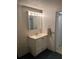 Bathroom vanity with mirror, cabinet and enclosed shower, plus towel rack at 209 Roma Rd, Venice, FL 34285