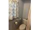 Bathroom featuring floral shower curtain, toilet, and towel rack for convenience at 209 Roma Rd, Venice, FL 34285
