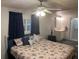 Bedroom with queen bed, en-suite bathroom and neutral walls and curtains for natural lighting at 209 Roma Rd, Venice, FL 34285