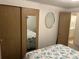 Bedroom features mirrored closet doors and a nautical-themed bedspread at 209 Roma Rd, Venice, FL 34285