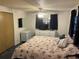 A bedroom featuring a queen bed, dresser, mirror, and overhead lighting with a ceiling fan at 209 Roma Rd, Venice, FL 34285