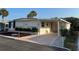 Charming single-story home with covered parking, lush landscaping, and a welcoming entrance at 209 Roma Rd, Venice, FL 34285