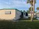 Exterior angle of home displaying the attached screened in porch at 209 Roma Rd, Venice, FL 34285