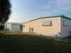 View of home's exterior featuring manicured lawn at 209 Roma Rd, Venice, FL 34285