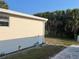 Exterior view showcasing the well-maintained vinyl siding and tropical landscaping at 209 Roma Rd, Venice, FL 34285