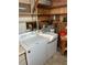 A laundry room featuring a white Amana washer and dryer set at 209 Roma Rd, Venice, FL 34285