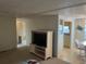 Cozy living room area with a flat screen TV and open to the dining area at 209 Roma Rd, Venice, FL 34285