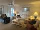 Inviting living room featuring a ceiling fan, neutral carpet, and comfortable seating at 209 Roma Rd, Venice, FL 34285