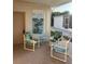 Cozy covered patio featuring comfortable seating and a decorative pelican art piece at 209 Roma Rd, Venice, FL 34285