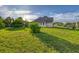 A spacious, grassy backyard featuring a view of the house and a fenced-in area at 2091 Marlin Way, Englewood, FL 34224