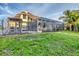 An expansive backyard showcasing a screened pool area and a secure fenced-in area at 2091 Marlin Way, Englewood, FL 34224