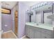 Bathroom with a glass shower, single sink vanity, and a mirrored medicine cabinet at 2091 Marlin Way, Englewood, FL 34224