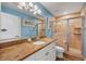 Bright bathroom with a granite countertop vanity, a tile shower, and a modern sink at 2091 Marlin Way, Englewood, FL 34224