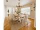 Elegant dining room with a decorative chandelier and seating for six, perfect for entertaining guests at 2091 Marlin Way, Englewood, FL 34224