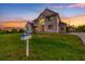 Charming two-story home with lush green lawn and whimsical mailbox at twilight at 2091 Marlin Way, Englewood, FL 34224