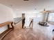 Open hallway with wood-look herringbone tile, a wrought iron banister, and views of the living room and staircase at 2091 Marlin Way, Englewood, FL 34224