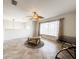 Bright living room with herringbone tile, a ceiling fan, and a large window with sheer curtains at 2091 Marlin Way, Englewood, FL 34224