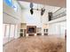 Open-concept living room with fireplace, built-in shelving, and access to a patio area at 2091 Marlin Way, Englewood, FL 34224