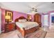 Traditional main bedroom with wood furniture, an area rug, and mauve-painted walls at 2091 Marlin Way, Englewood, FL 34224