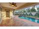 Enclosed pool area featuring a pristine pool with a dolphin mosaic, alongside a relaxing hot tub at 2091 Marlin Way, Englewood, FL 34224