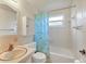 Clean bathroom with shower/tub combo, updated vanity, and window at 401 Peach St, Venice, FL 34285